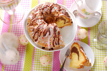 ring cake with icing and chocolate glaze on easter table