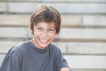 portrait of a happy preteen boy outdoors with plain background © atikinka2