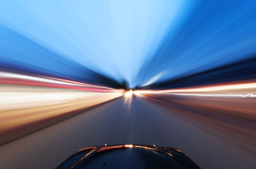 A car driving on a motorway at high speeds,