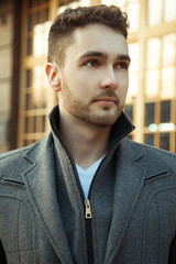 Street fashion.Portrait of handsome man in trendy casual coat.