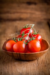 a bunch fresh organic cherry tomatoes in a bowl