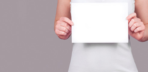Woman holding a blank paper