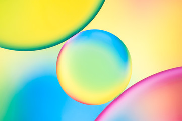 drops of oil and air bubbles on the water