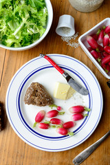 plate with radish and butter on a table