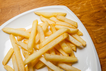 Tasty golden french fries on a plate
