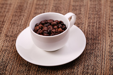 Cup with coffee beans, close up