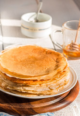 thin pancakes with honey and sour cream, rustic