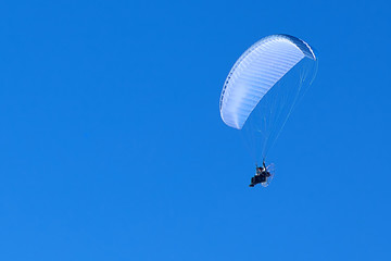 powered paragliding in the blue sky