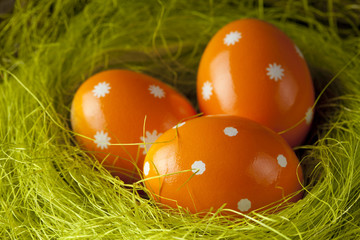 Orange Easter eggs in the nest