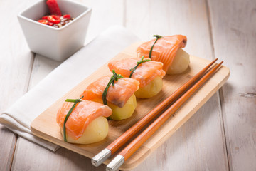 homemade sushi with potatoes and fresh salmon, selective focus