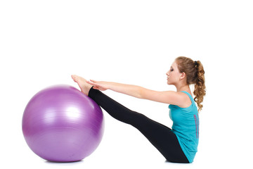 Girl-fitness instructor,shows exercises with a large ball.