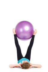 Girl-fitness instructor,shows exercises with a large ball.