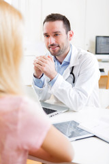 Young attractive doctor listening his patient