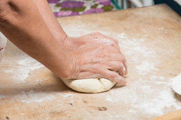 hand with rolling pin and flour