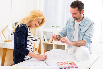 Two attractives architect working at the office