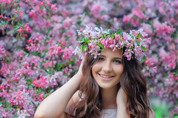 young woman in a park with a spring wreath