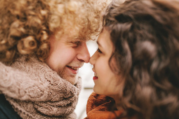Young curly couple smiling at each other
