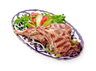 Meat on a grill with vegetables