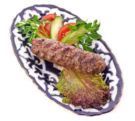 Meat on a grill with vegetables