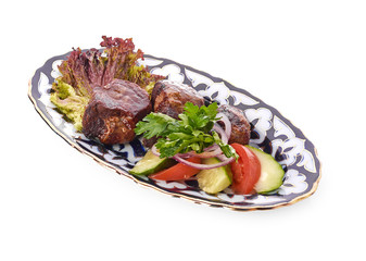 Meat on a grill with vegetables