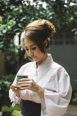 Asian woman in yukata holding tea cup with vintage effect 