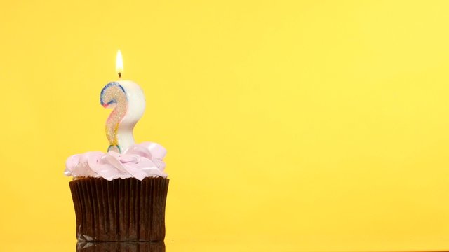 Birthday cupcake with candle question mark.