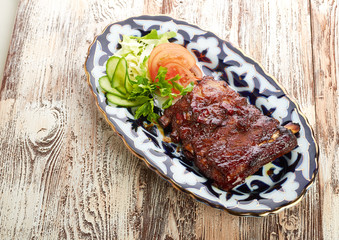 Meat on a grill with vegetables