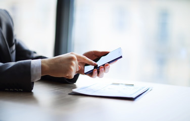 Close up of a man using mobile smart phone