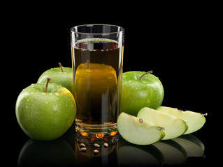 Three green apples and juice glass