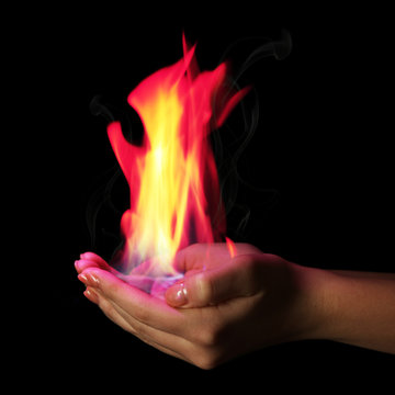 Hands with fire isolated on black