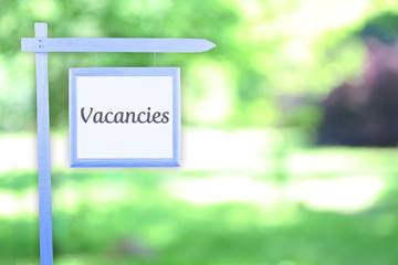 Signboard with text Vacancies near hotel