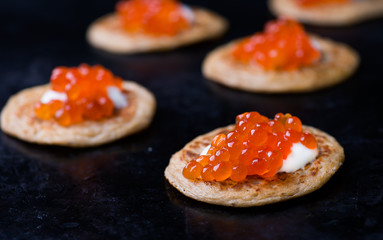 Buckwheat blini with red caviar and sour cream