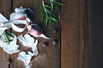 Raw garlic and spices on wooden table