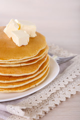 Stack of delicious pancakes with butter