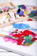 Professional art materials on color wooden background