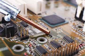 Repairing of computer motherboard, macro view