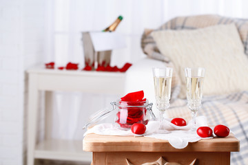 Champagne glasses and rose petals for celebrating Valentines