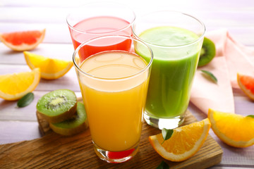 Fototapeta premium Fresh juices with fruits on wooden table