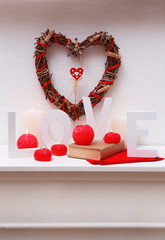 Romantic still life with wicker heart and candle lights