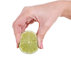 Female hand squeezing lime isolated on white