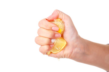 Female hand squeezing lemon isolated on white