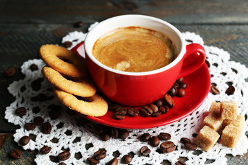 Cup of coffee and tasty cookies on wooden background