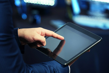 Male hand touching screen tablet close-up