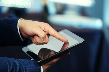 Male hand touching screen tablet close-up