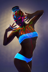 Seductive female dancer with luminous body art