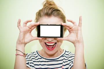 Young woman with smartphone over eyes
