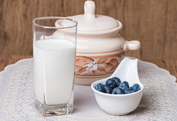 blueberries and milk products on wooden table