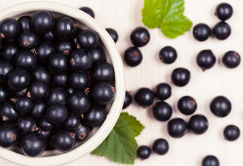 Black currant superfoods in a bowl on white background