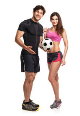 Athletic couple - man and woman with ball on the white