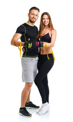 Happy athletic couple - man and woman with measuring tape on and